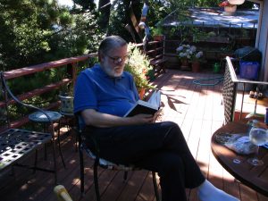 John Varley reading on Charlie’s deck