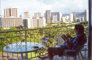 John Varley reading on balcony